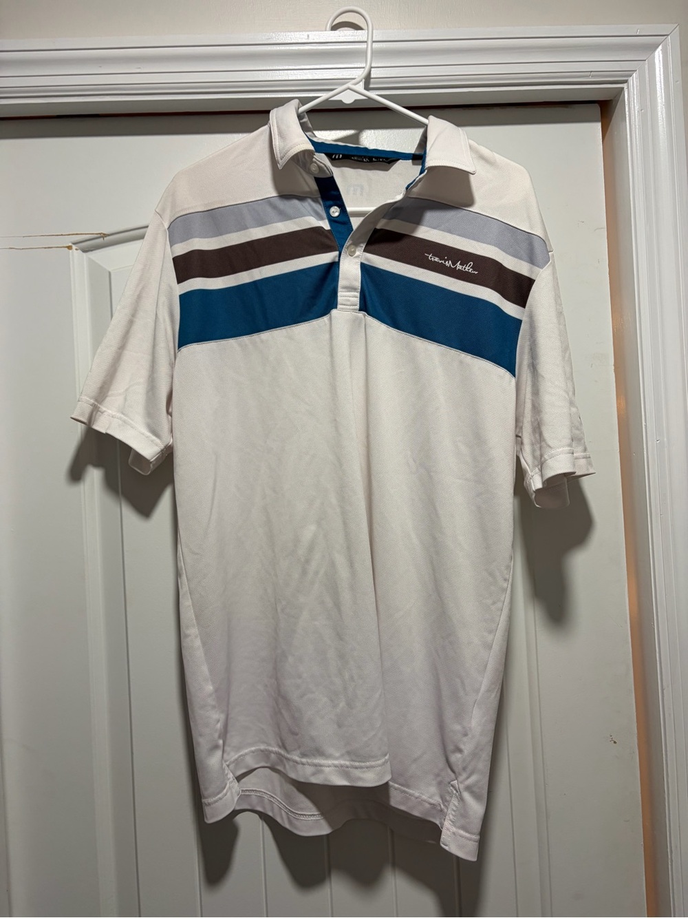 Travis Mathew White Polo with Blue and Gray Stripe Accents